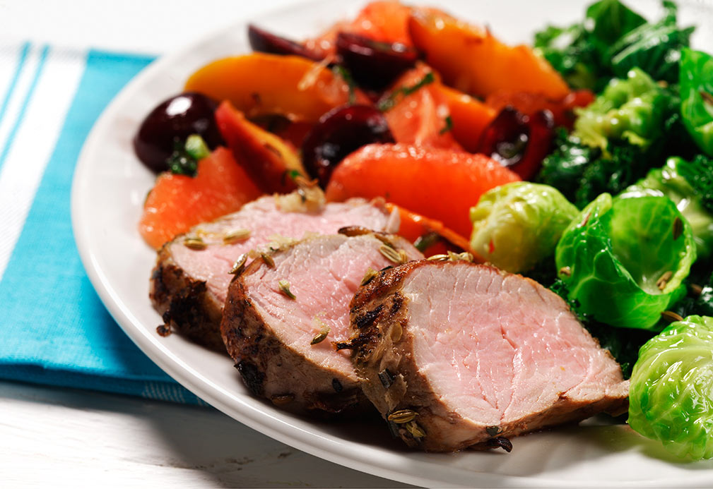Garlic Rosemary Pork Tenderloin with Fruit Compote Over Greens recipe made with canola oil by Carla Hall