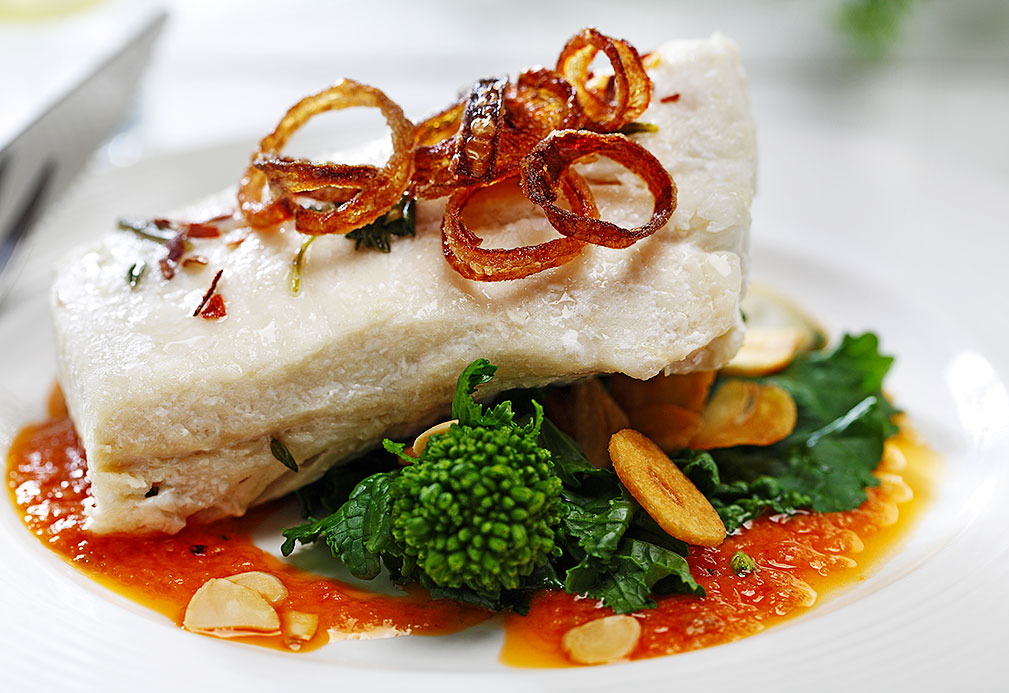 Slow Oil Poached Halibut Over Broccoli Rabe recipe made with canola oil by the Culinary Institute of America